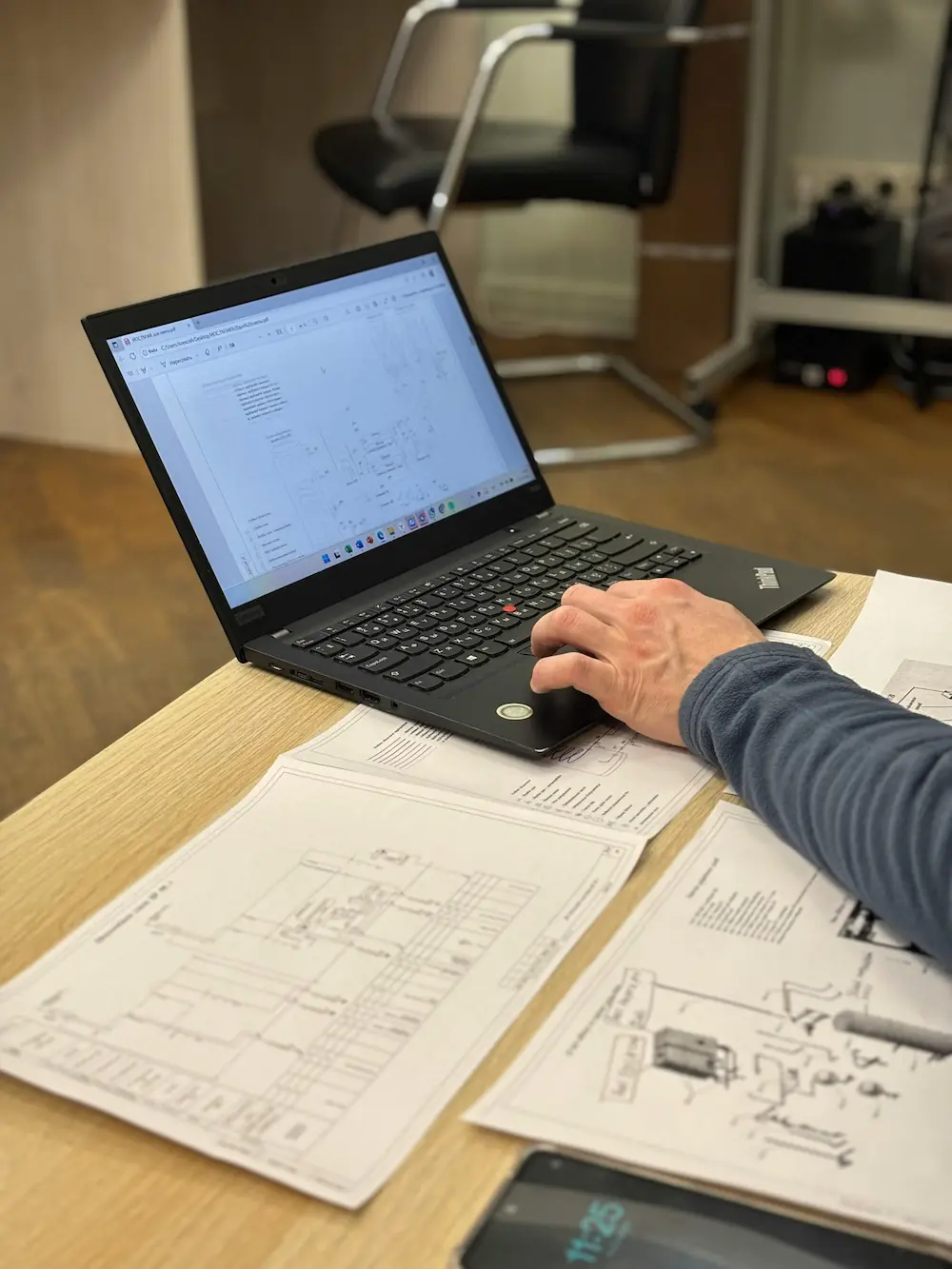 Electrical engineer reviewing technical drawings and wiring diagrams
