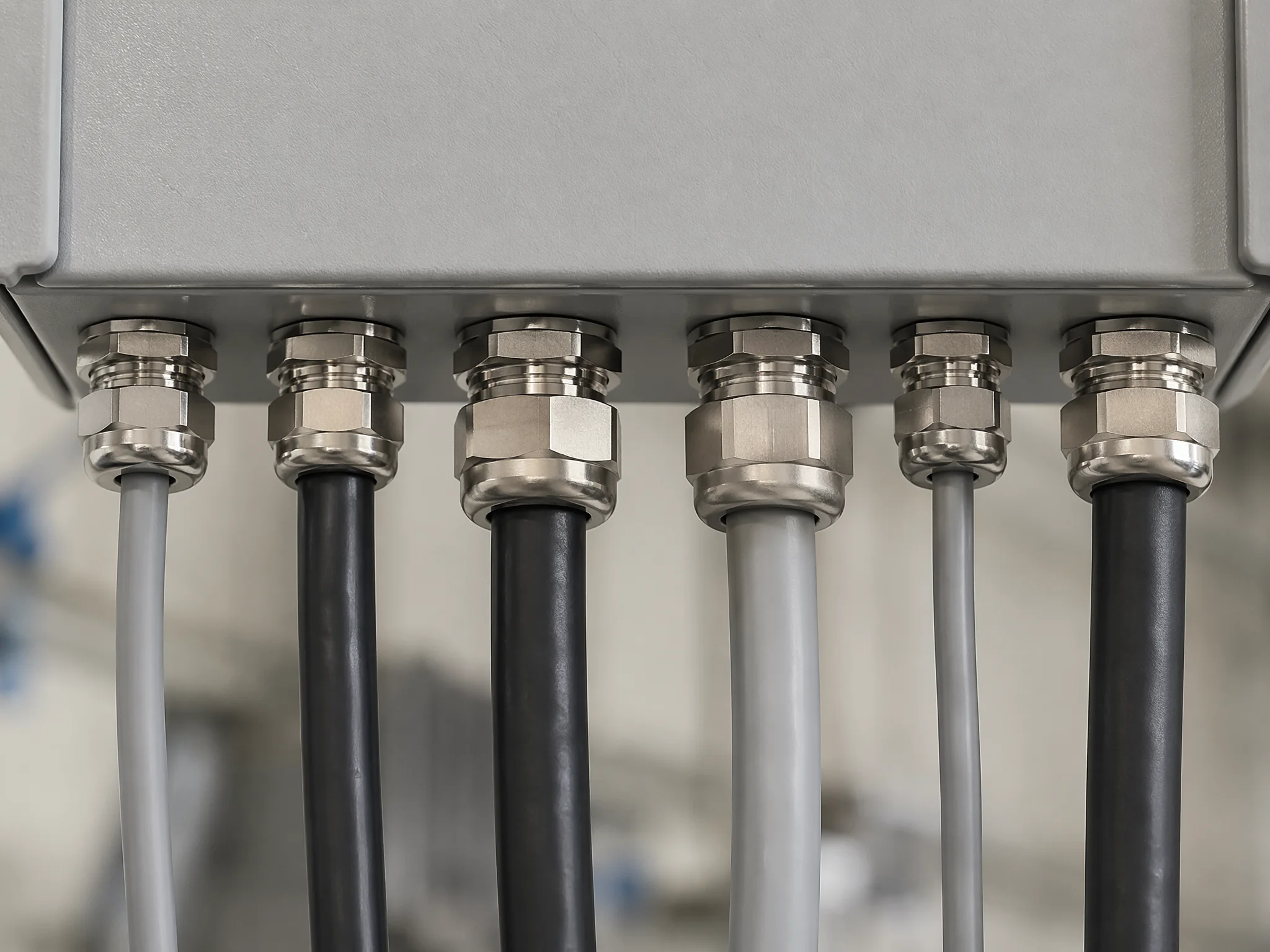 Cable glands installed in a control panel gland plate with multiple cable entries