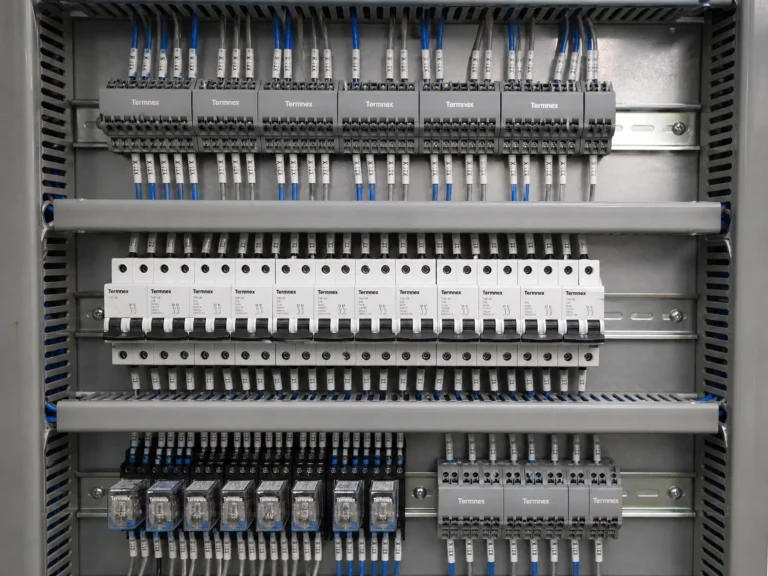 Control panel with DIN rail mounted terminal blocks circuit breakers and organized wiring