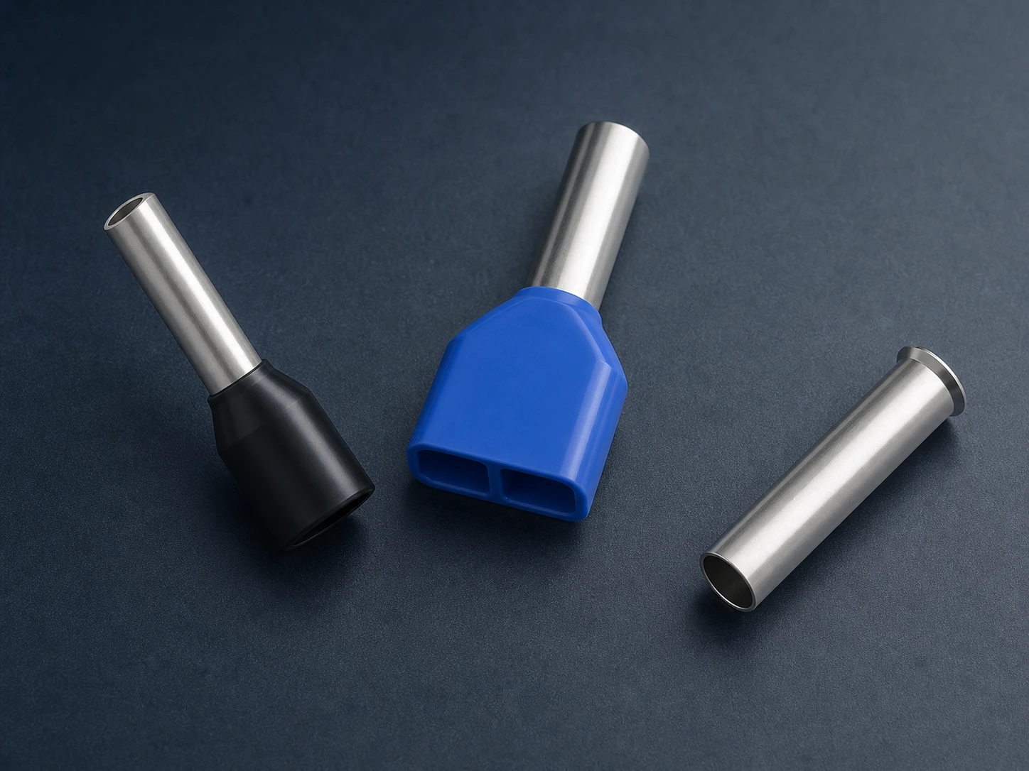 Insulated single, twin and non-insulated wire ferrules arranged on a dark graphite work surface
